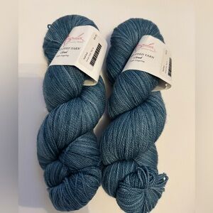 2 skeins Anzula light fingering 575 yards each.  Teal colorway